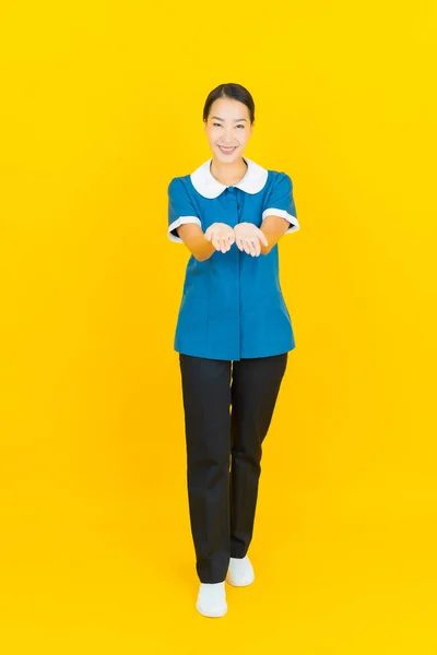 Portret Piękna Młoda Azjatycka Pokojówka Pokojówka Uśmiech Akcji Żółtym Tle — Zdjęcie stockowe