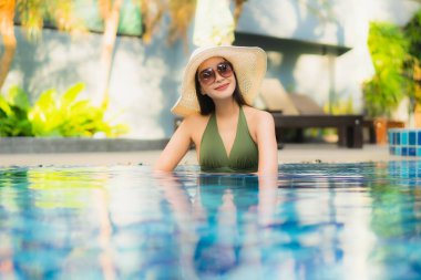 Güzel bir Asyalı kadın portresi. Tatilde dinlenmek için otel havuzunda dinleniyor.