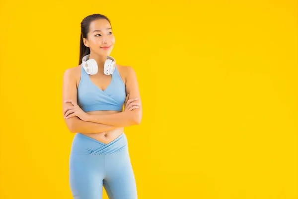 아름다운 아시아 여성의 초상화는 음악을 스마트폰 헤드폰으로 스포츠 복장을 — 스톡 사진