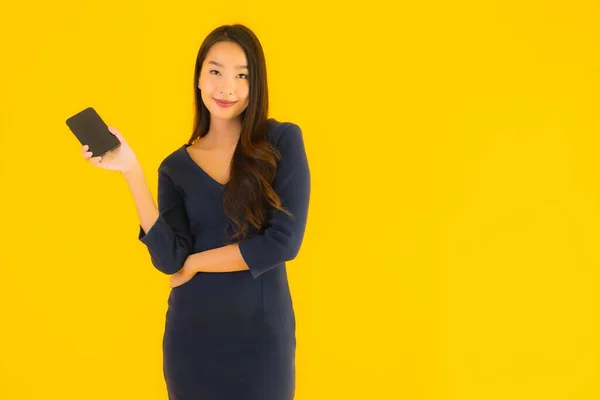 Портрет Красивая Молодая Азиатская Женщина Смартфоном Сотовым Телефоном Желтом Изолированном — стоковое фото