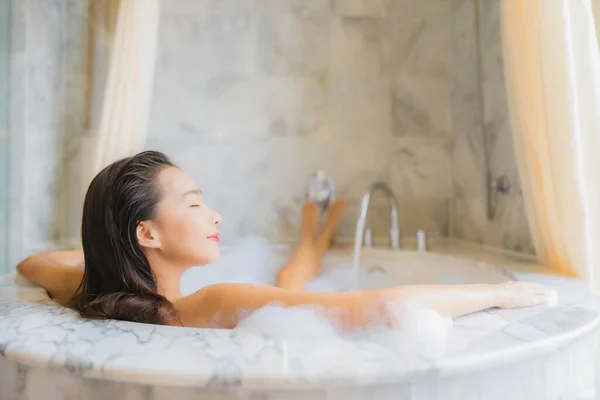 Portrait beautiful young asian woman relax take a bath in bathtub in bathroom interior