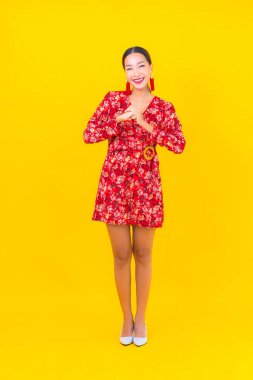 Güzel bir Asyalı kadının portresi Çin 'in yeni yıl konseptinde gülümsüyor. Renkli arka plan üzerine.