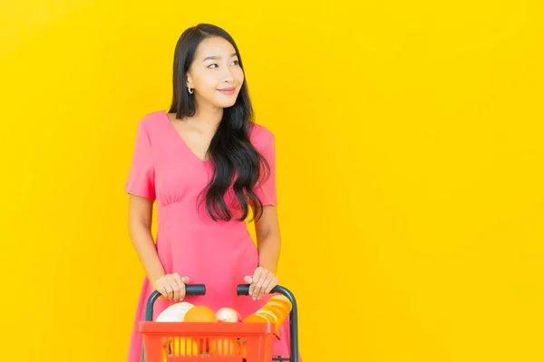 Portrait Beautiful Young Asian Woman Smile Grocery Basket Supermarket Yellow — Stock Photo, Image