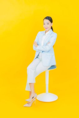 Portre güzel Asyalı kadın gülümsüyor. Renkli arka planda hareket var.