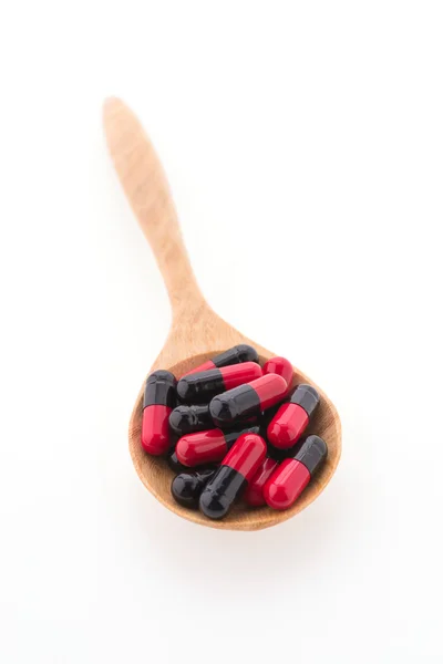 Tablet pill on wood spoon — Stock Photo, Image