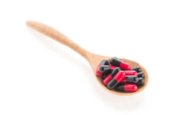 Pills drug on wooden spoon — Stock Photo, Image