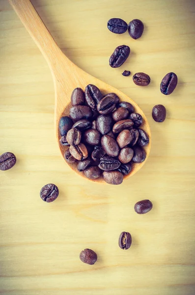 Coffee beans on spoon — Stock Photo, Image