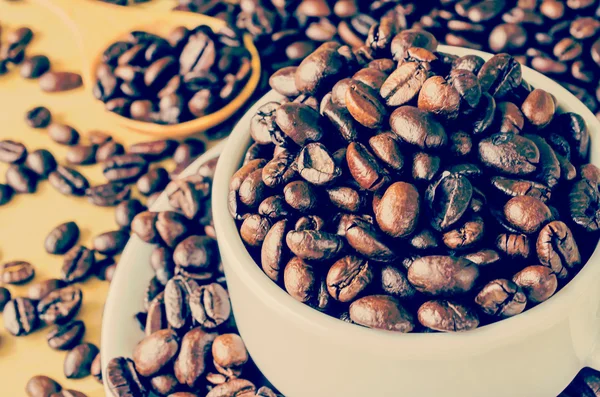 Coffee beans on cup — Stock Photo, Image