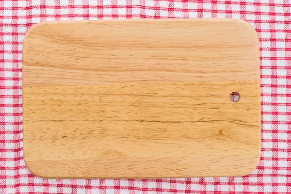 wood cutting board on tablecloth