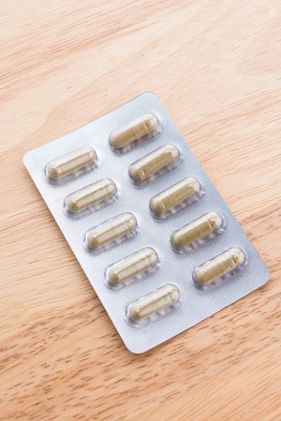 Pill on wooden background — Stock Photo, Image