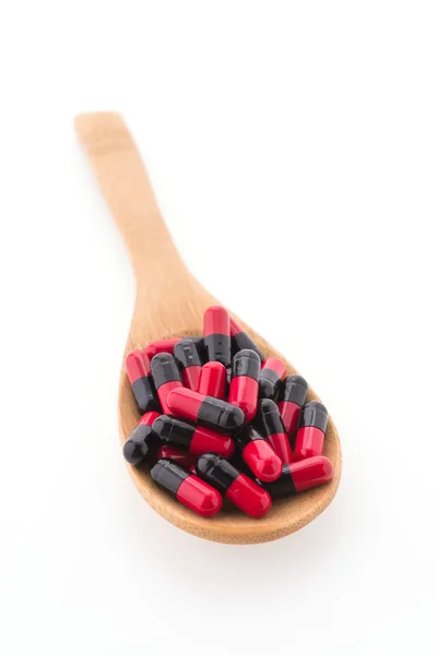 Tablet pills on wood spoon — Stock Photo, Image