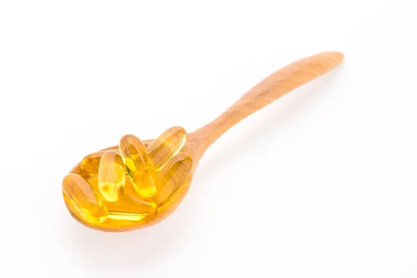 Fish oil in wooden spoon — Stock Photo, Image