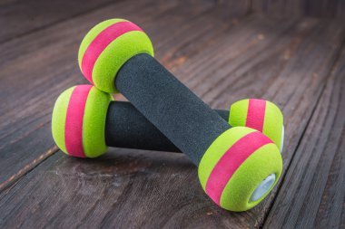 dumbbell on wood background