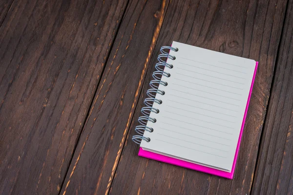 Notebook na dřevěné pozadí — Stock fotografie