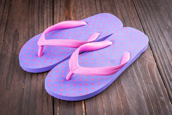 Slipper on wooden background — Stock Photo, Image