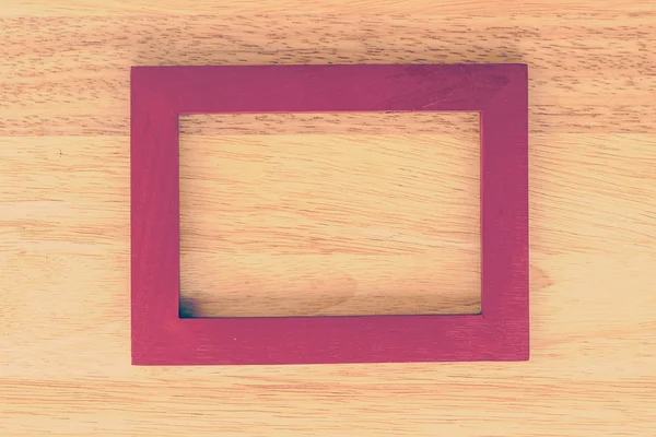 Frame on wooden background — Stock Photo, Image