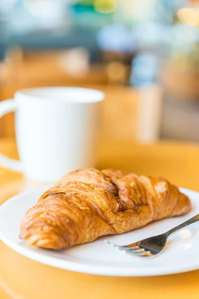 Croissant on wooden table — Stock Photo, Image