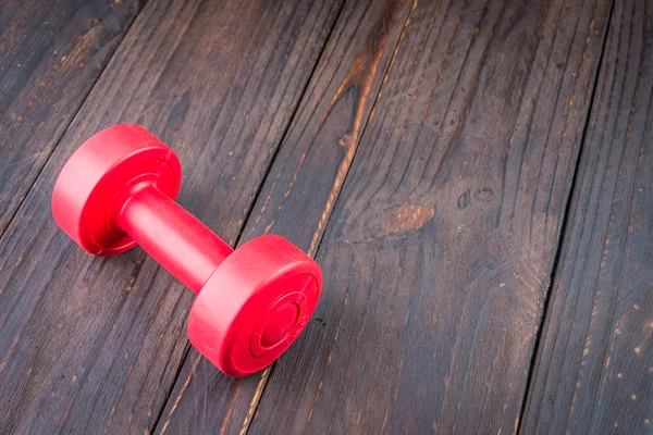 Dumbbell on wood background — ストック写真