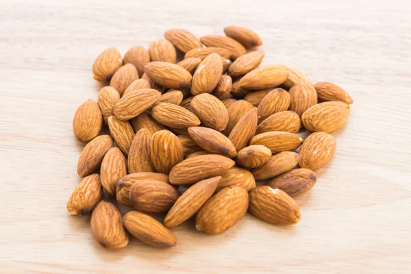 Almond on wooden background — Stock Photo, Image