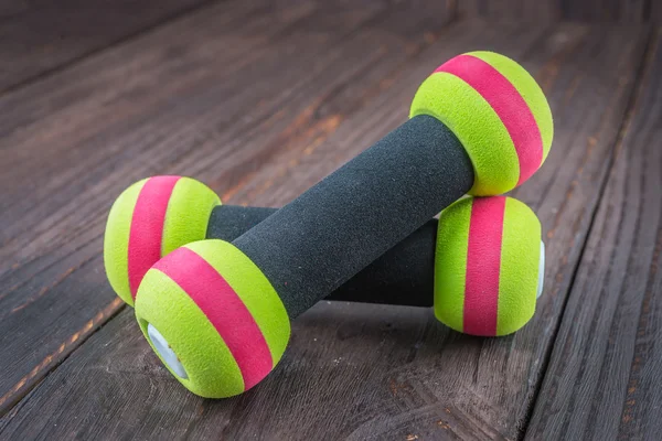 dumbbell on wood background