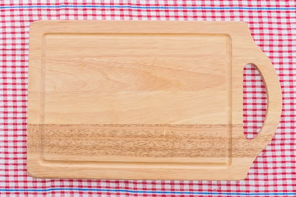 wood cutting board on tablecloth