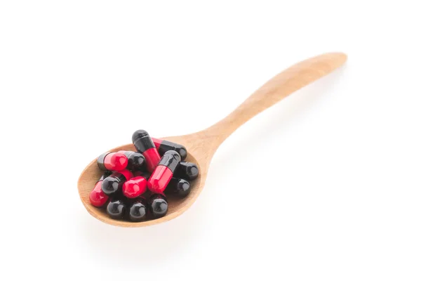 Pills drug on wooden spoon — Stock Photo, Image