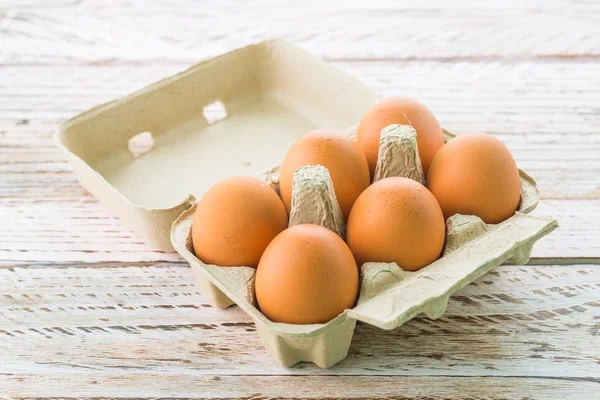 Eggs pack on wood background — Stock Photo, Image