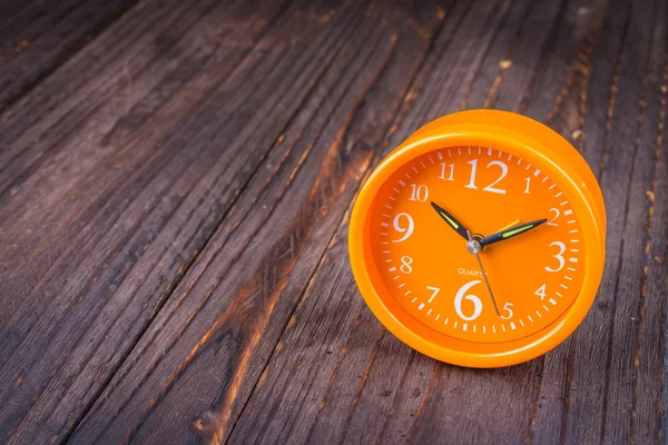 Clock on wood background