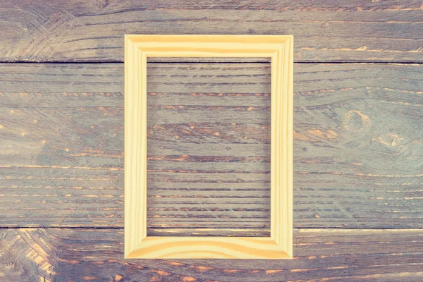 Photo frame on wooden background