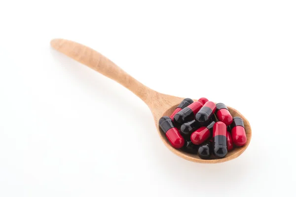 Tablet pill on wood spoon — Stock Photo, Image