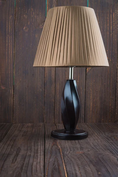 Lamp on wood background — Stock Photo, Image