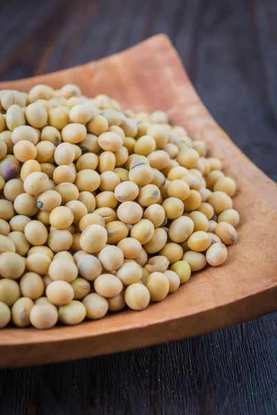 Soy beans on wooden background — Stock Photo, Image