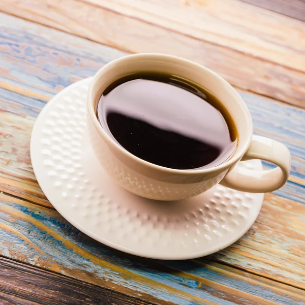 Coffee cup on wooden table — Stock Photo, Image