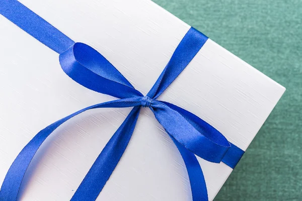 Gift box with blue ribbon — Stock Photo, Image