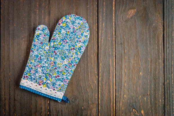 Keuken handschoen op houten achtergrond — Stockfoto