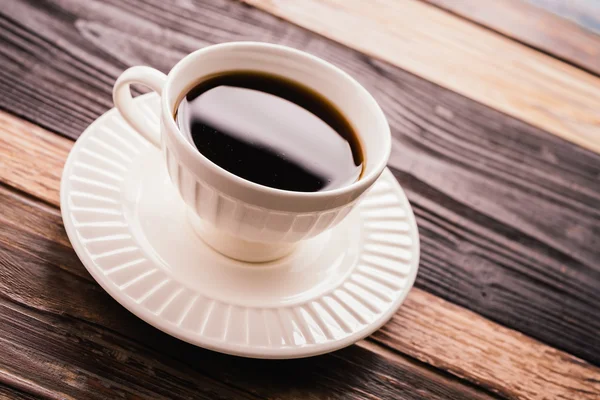 Coffee cup on wooden background — Stock Photo, Image