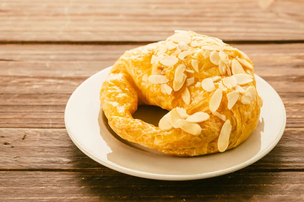 Croissant on white dish — Stock Photo, Image