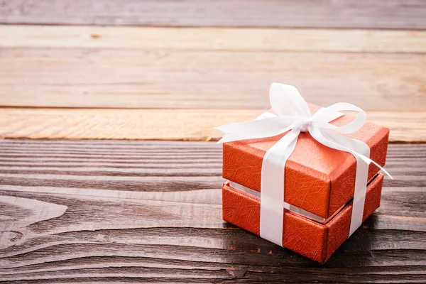 Gift box on wood background — Stock Photo, Image