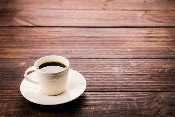 Coffee cup on wooden background — Stock Photo, Image