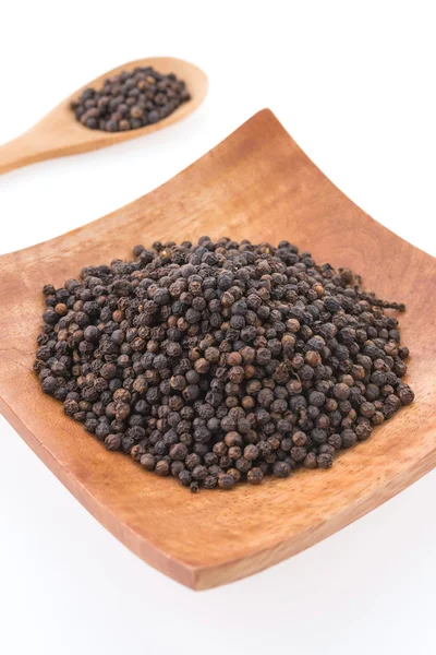 Black pepper in wooden bowl — Stock Photo, Image