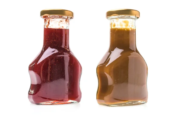 Bottiglie di marmellata di caramello e fragole — Foto Stock