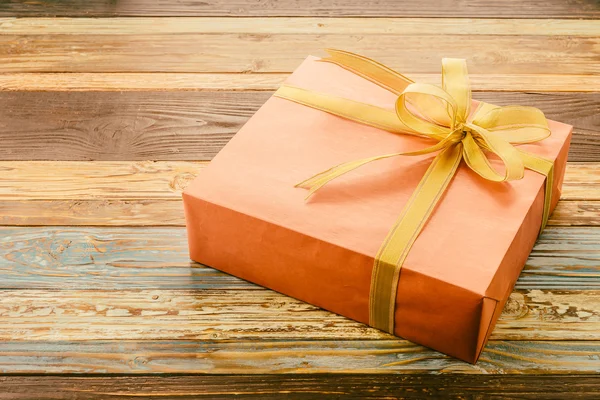 Gift box on wooden background — Stock Photo, Image