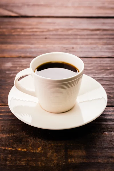 Coffee cup on wooden table — Stock Photo, Image