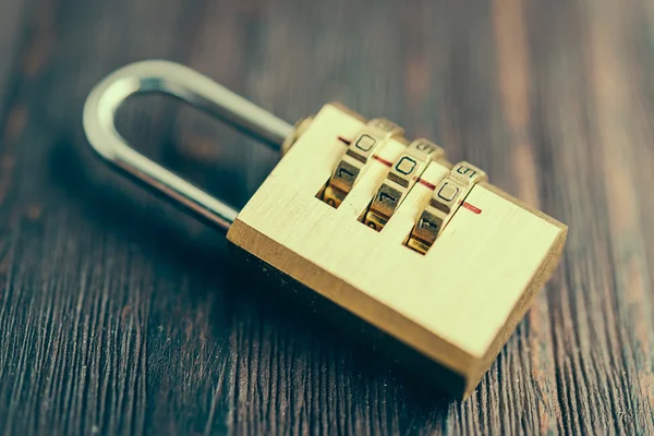 Golden pad lock on wood — Stock Photo, Image