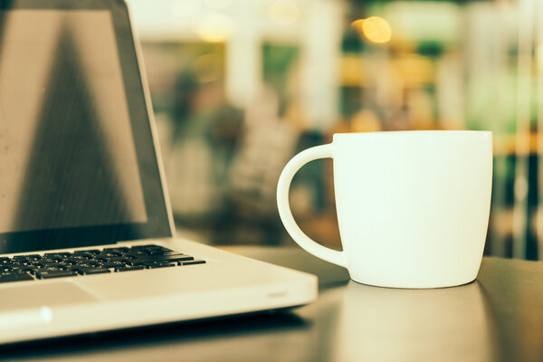 Laptop and coffee cup