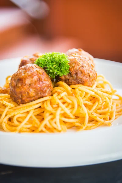Spaghetti and meatballs on white dish