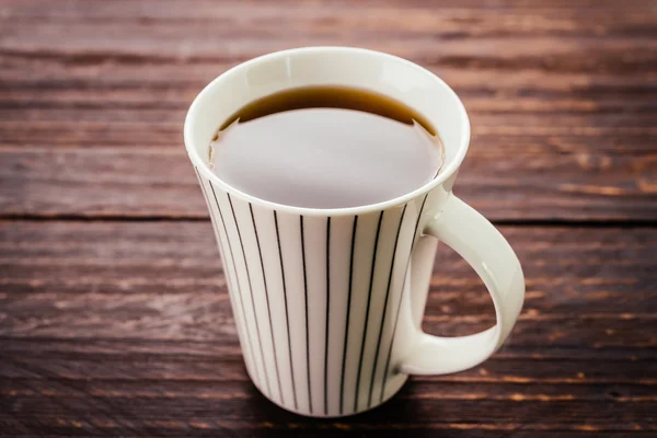 Coffee mug on wooden table — Stock Photo, Image