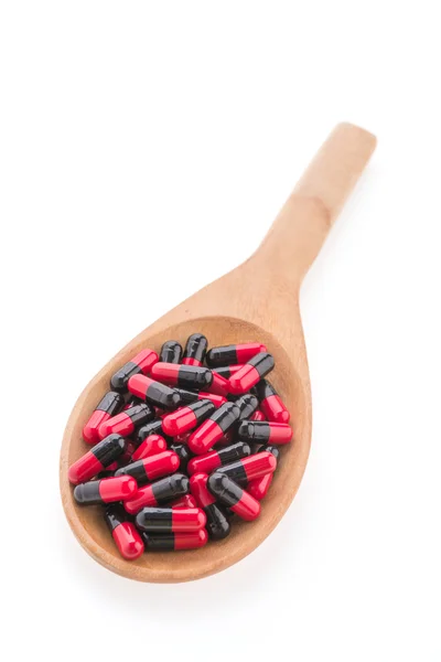 Pills drug on wooden spoon — Stock Photo, Image