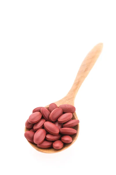 Pills drug on wooden spoon — Stock Photo, Image