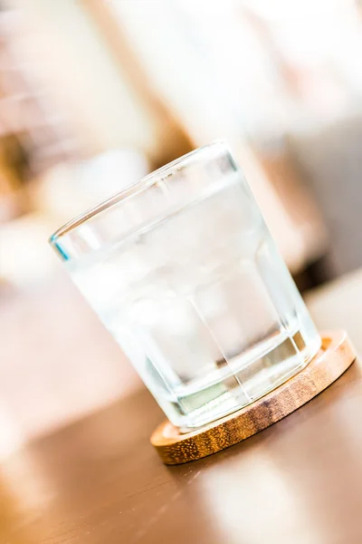Water glass on wooden table — Stock Photo, Image